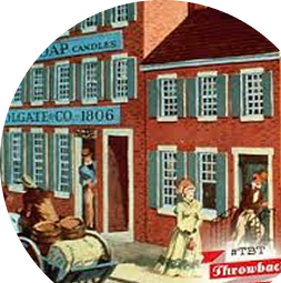 Cuadro de una escena callejera del siglo XIX en la que se ve a gente caminando, una mujer con una sombrilla y un edificio con contraventanas azules y un letrero de «Colgate Co. 1806».